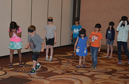 Children in NFB Childcare play red light, green light.